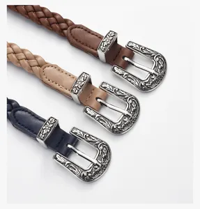 Detailed view of vintage braided women's belts with ornate metal buckles in three colors.