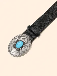Vintage embossed leather belt detail featuring a striking oval turquoise silver buckle western style.