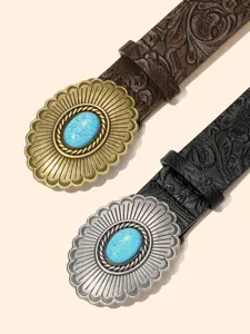 Detailed shot of western cowboy style embossed leather belts with large turquoise stone buckles.