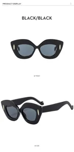 Chic occhiali da sole cat-eye oversize da donna, spessa montatura nera con dettagli in metallo.