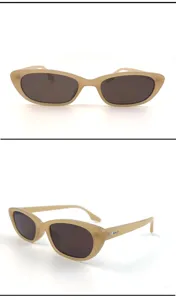 Trendy retro small cat-eye sunglasses for women, chic nude frame with dark lenses.