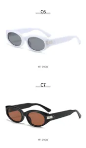 Vista detallada de gafas de sol ovaladas estilo ojo de gato en blanco y negro con detalles metálicos.