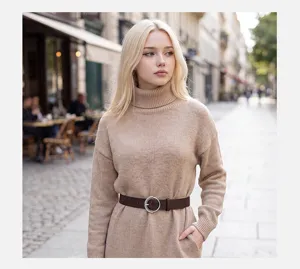 Detailed shot of a stylish brown leather belt with round metal buckle worn on knit sweater.