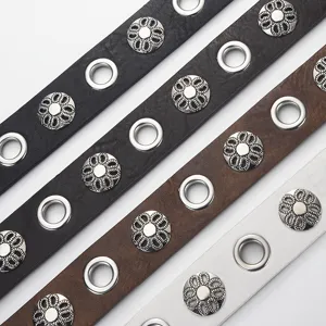 Vintage punk style wide leather belt with metal eyelets and decorative flower shaped rivet studs.