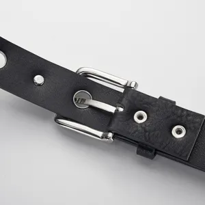 Black leather belt with silver metal buckle and eyelet design, retro punk style fashion accessory.