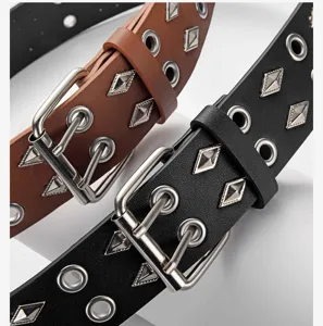 Detail shot of punk style double grommet wide leather belt with metal studs and pin buckle.