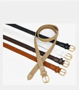 Detail view of women's braided PU leather belt with gold buckle, stylish accessory.