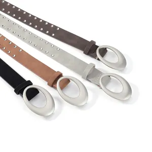 Close-up details of vintage suede studded waist belts with large oval metal buckles.