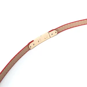 Women thin red beige leather belt detail view with metal clasp fashion accessory elegant style