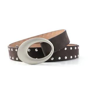 Retro suede studded belt detail showing the large oval buckle and metal hardware.