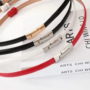 Women's thin patent leather belt with metal clasp, stylish dress accessory for skirts.