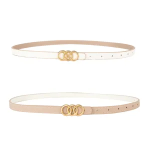 Close-up detail of women's thin leather belt featuring a sleek gold interlocking ring buckle design.