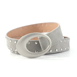 Grey suede rivet belt detail showcasing large silver oval buckle and metal studs on strap.