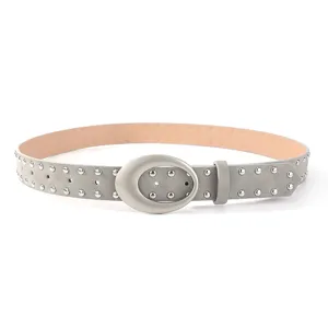 Detailed view of women's grey suede belt featuring metallic studs and a stylish oval silver buckle.