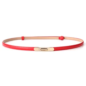 Close-up detail of the slim red women belt featuring elegant gold metal buckle hardware.