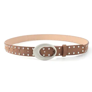 Detailed view of the vintage brown suede studded belt, featuring a silver oval buckle and double rivets.