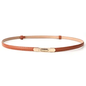 Detail shot of women's thin brown leather belt with elegant gold metal interlocking buckle.