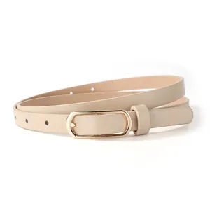 Minimalist women's PU leather thin belt in beige with gold buckle for trousers and dresses.