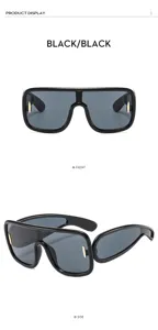 Stylish black futuristic wrap-around sunglasses featuring grey lenses and gold accents.
