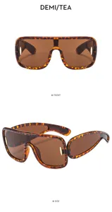 Detailed view of futuristic tortoise shell flat top shield sunglasses with metal decor.
