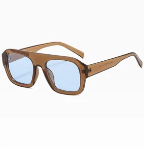 Detailed view of trendy square sunglasses with brown transparent frame and light blue lenses.