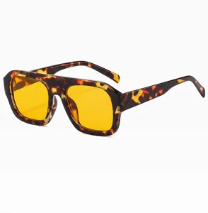 Detailed view of stylish square tortoiseshell sunglasses featuring bold frames and yellow lenses.