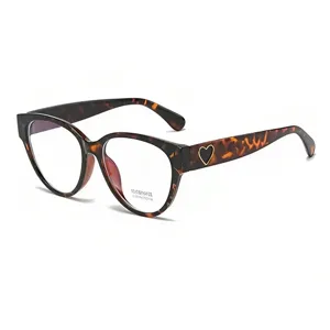 Retro tortoise cat-eye glasses detail close-up showcasing the chic heart temple accent.