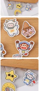 Detailed close-up shot of cute astronaut acrylic brooches, featuring various cartoon animal designs.