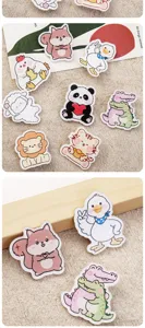 Close-up detail of cute cartoon animal acrylic badges featuring ducks and squirrels.
