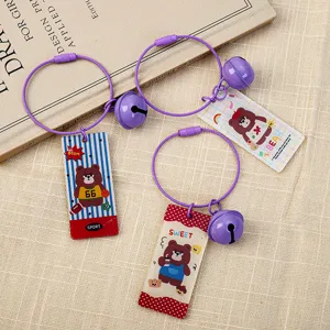 Cute cartoon bear acrylic keychain with steel wire ring and bell for schoolbag decoration.