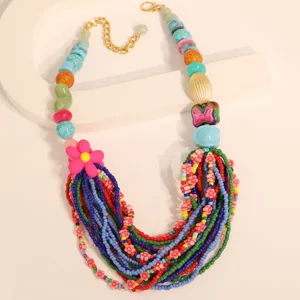 Close-up detail of a colorful Bohemian multi-layer beaded necklace featuring a flower charm