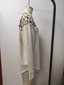Detailed side view of a beige women shirt jacket with leopard print shoulder panels