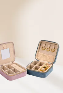Detailed view of portable velvet jewelry box with organized compartments and mirror.