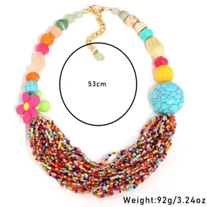 Close-up of bohemian style multi-layer colorful beaded necklace with a pink flower pendant