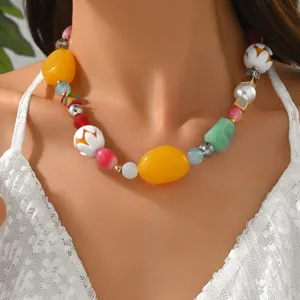 Detailed view of a colorful dopamine style resin beaded necklace worn by a model.