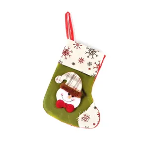 Green Christmas stocking with cute 3D snowman face and festive snowflake pattern for holiday decor