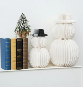 Detailed view of white honeycomb paper snowman ornaments for holiday and home decor set.