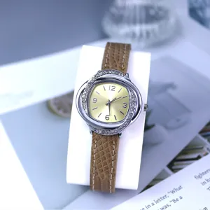Detail shot of women quartz watch with crystal floral bezel and brown leather strap.