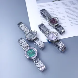 Detail view of women quartz watch with rhinestones bezel, metal steel strap and colorful dial options.