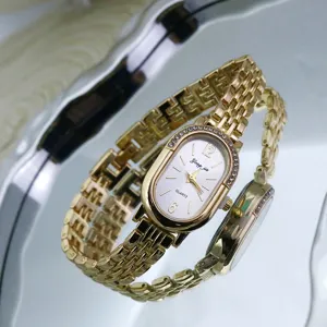 Elegant gold quartz watch with oval rhinestone bezel and metal chain strap for women.