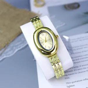 Elegant oval gold-plated women wristwatch with metal steel strap and vintage Roman numerals.