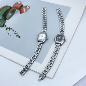 Elegant women's quartz watch with small tonneau dial and metallic bracelet strap, chic style.