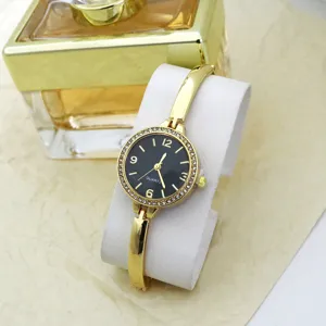 Women's gold bangle quartz watch with rhinestone bezel, black dial and elegant style fashion reloj.