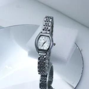 Close-up of a women's quartz watch with tonneau dial and silver metal link bracelet.