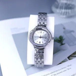 Silver quartz wristwatch with rhinestone bezel, elegant steel strap, stylish detail.
