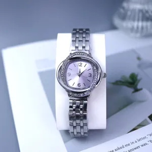 Women's quartz watch with crystal swirl bezel, silver metal strap and purple dial for daily wear.