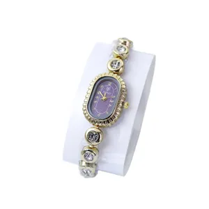 Elegante goldene Damen-Armbanduhr mit ovalem lila Zifferblatt und Strass-Armband Ansicht