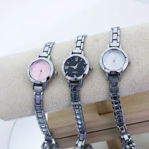 Primo piano di tre eleganti orologi da polso al quarzo da donna con cinturino in metallo.