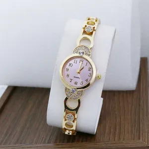 Elegant gold quartz wristwatch featuring a pink dial and sparkling rhinestone bracelet details.