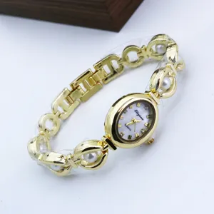 Elegant gold-tone women quartz bracelet watch with embedded pearls and mother-of-pearl oval dial.